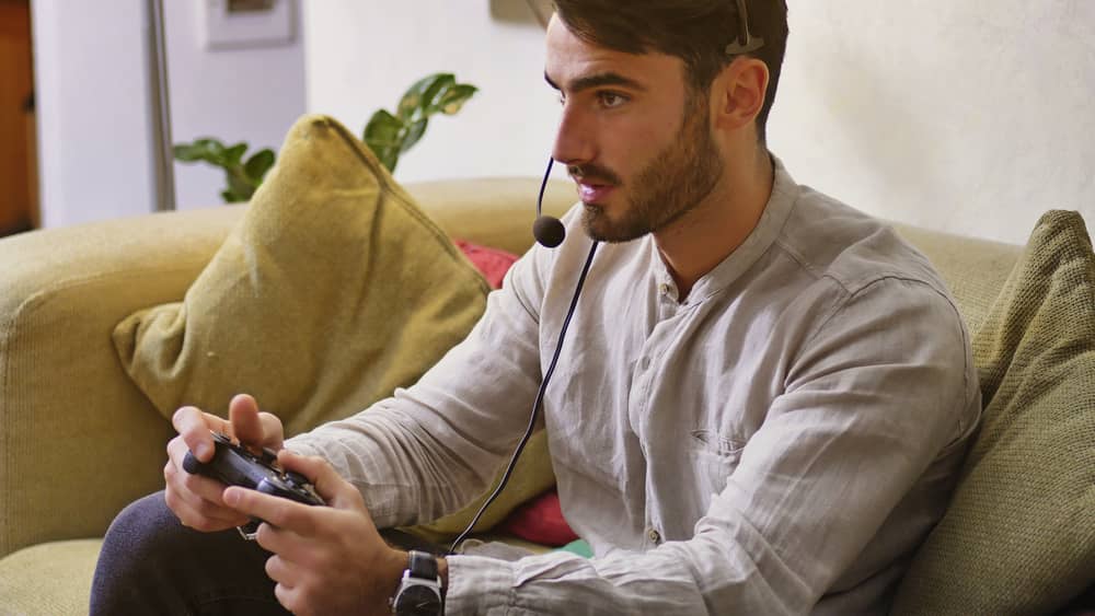 Man playing video games using ultra-low latency headset