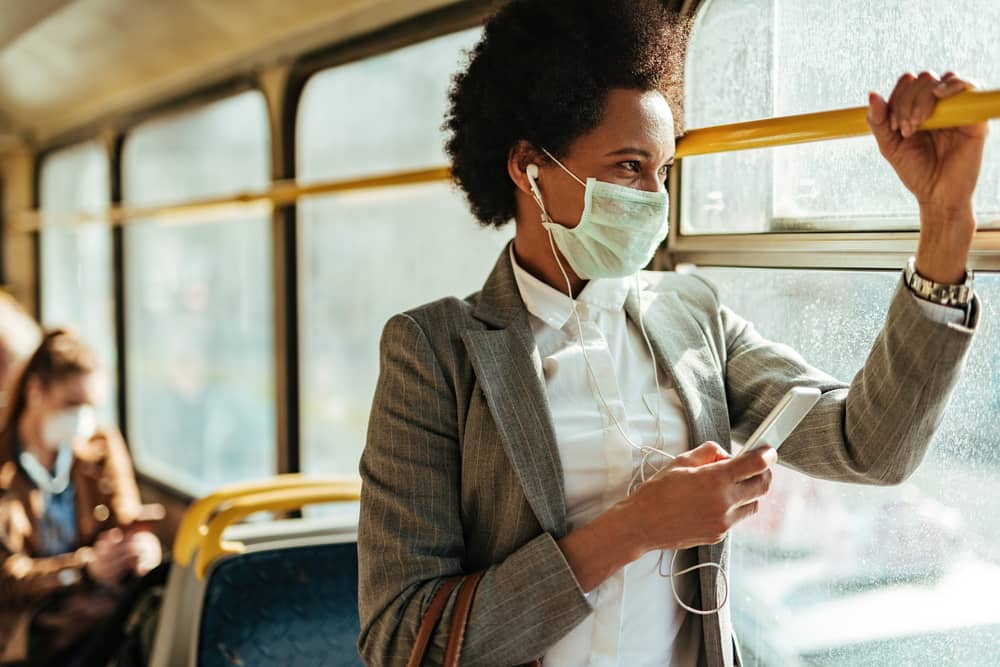 Woman in mask on public bus